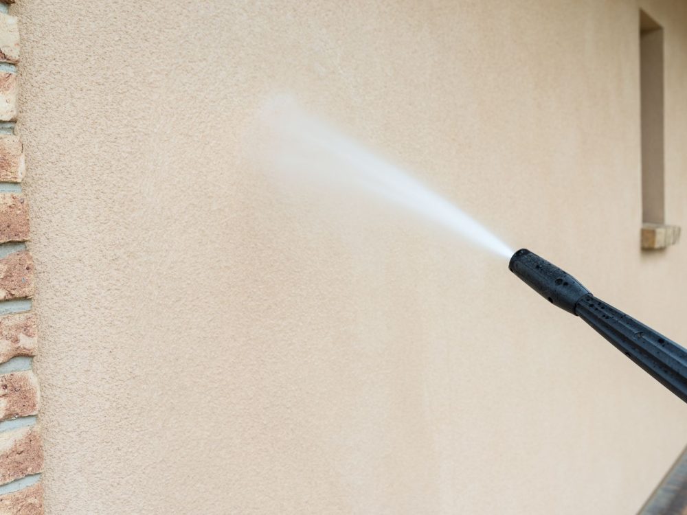 power washing the wall - cleaning the facade of the house